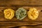 Three bundles of wheat pasta on wood table