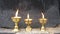 Three burning candle on the golden candlestick