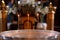 Three burning candles on a baptismal font