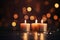 Three burning candles creating a celebratory mood, enhanced by the blurred lights. This image encapsulates the festive concept and