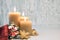 Three burning candles with golden Christmas decorations on rustic neutral background. Happy Third Advent! This image is toned and