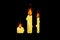 Three burning candles are painted in the style of pixel art.