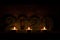 three burning candles stand on a shelf, next to the numbers two thousand twenty and illuminate them, against the background of a