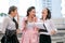 Three business Asian girls are acting as happy and exciting outside the office during day time