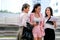 Three business Asian girls are acting as happy and exciting outside the office during day time