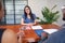 Three business colleagues sit around conference table, meeting smile discuss