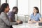 Three business people sitting at a conference table and discussing during a business meeting