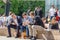 Three businessmen on their lunch break in Cabot Square, Canary Wharf