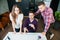 Three businessmen watch internet monitor screen hold credit card