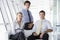 Three businesspeople sitting in office lobby