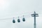 Three cable cars against cloudy sky in summer