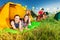 Three campers relaxing in their tent at campsite