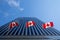 Three Canadian flags in front of a business building in Ottawa, Ontario, Canada.