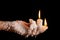 Three candle sticks on fingers buring