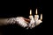 Three candle sticks on fingers buring artistic conversion