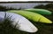 Three Canoes Lay Upside Down On Bank Of Lake