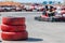 Three car tires are stacked on top of each other on the go-kart track. the boundaries of the sports zone, karting competitions