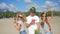 Three Carefree Young Friends Fooling on the Beach and Dancing with Exotic Thai Fruits. Vegan Dance. Phangan, Thailand