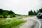 Three cars driving on a bend on a country highway road