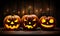 Three carved jack o lantern pumpkins sitting on a table