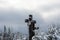 Three catholic crosses after a heavy snowstorm near a pine forest