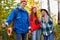 Three caucasian friends take break, talk during hike in the forest