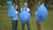 Three Caucasian volunteers raising up garbage bags and smiling. Portrait of happy proud eco-activists posing with