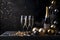 Three champagne glasses, gold streamers and confetti on dark background.New Year\\\'s Eve background, banner.