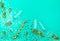 Three champagne glasses on trendy mint background with golden star shaped confetti and party streamers. Holiday concept