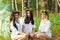 Three charming woman sitting in the forest