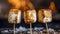 Three Charred And Toasted Marshmallows On Sticks With A Blurry, Fiery Backdrop, Showcasing Varying Shades