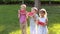 Three cheerful happy kids eat watermelon in summer in the park.