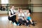 Three cheerful sportswomen laughing and having fun after workout in the gym. Cute female take a rest after hard physical