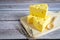 Three cheese on wooden tray on rustic wooden table