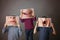 Three children, boy brothers, showing different emotions, hiding behind their expression