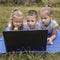 Three children are carefully studying