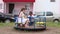 Three children play on carousel on playground