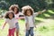 Three Children Playing In Woods Together