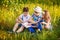 Three children read together in the summer. Brother and sister portrait in the village