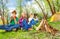 Three children resting near the wooden bonfire