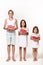 Three children in the studio stand on a white background and hold pieces of watermelon.