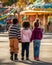 Three children with their backs to the camera looking at an amusement park. Generative AI
