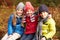 Three Children On Walk Through Winter Woodland