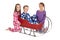 Three children in winter pajamas around a sleigh