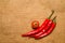 Three Chile peppers and Cherry tomat on very old cloth