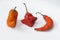 Three chili peppers on white background.