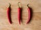 Three chilli peppers on wood