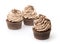 Three chocolate cupcakes with whipped cream