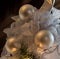 Three Christmas balls with glittering lace ribbons