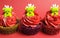 Three Christmas cupcakes with fun and quirky reindeer faces